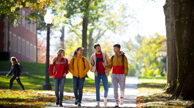A group of international students walking together on a university campus